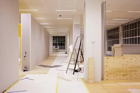 Corridor during fit-out with ceiling and services in progress