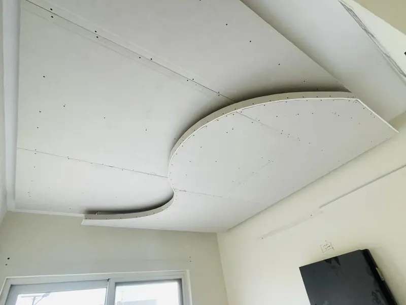 Curved gypsum ceiling feature under construction