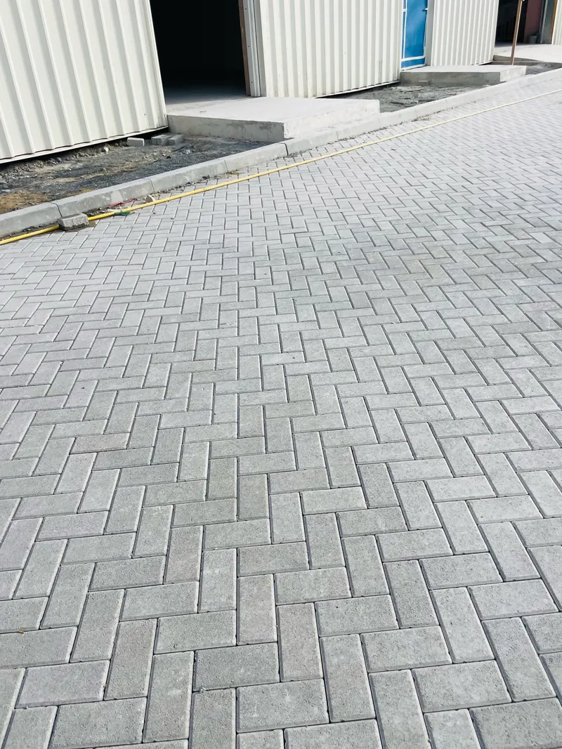 Grey interlock paving, warehouse yard