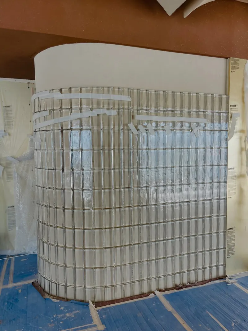 Curved glass block wall under construction — detail