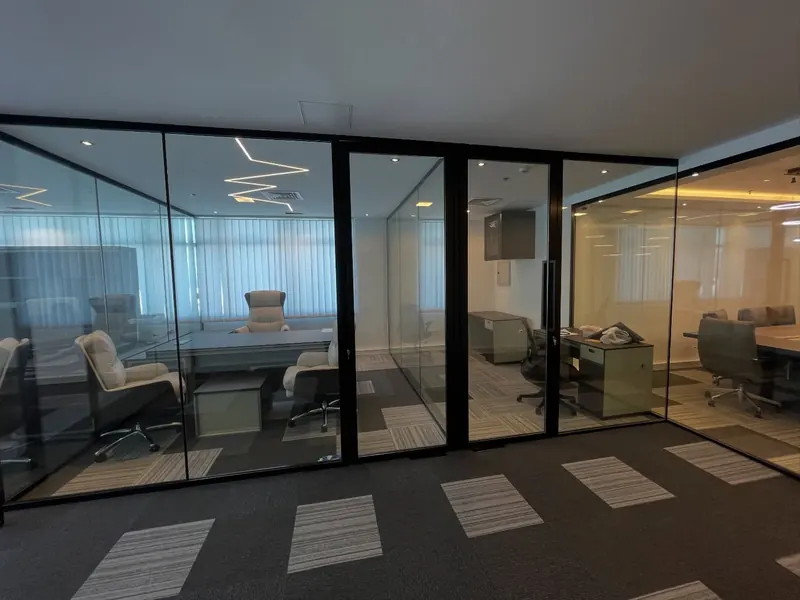 Office fit-out, glass partitions and carpet tiles — detail