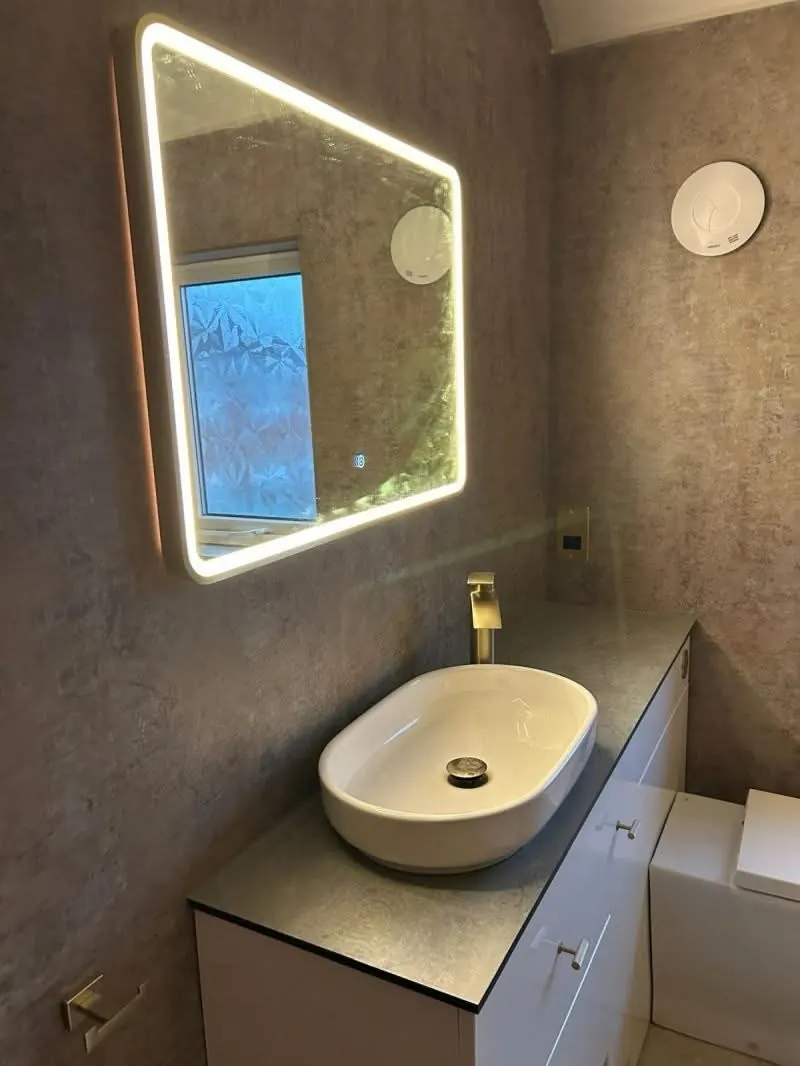 Completed bathroom renovation with basin, mirror and shower